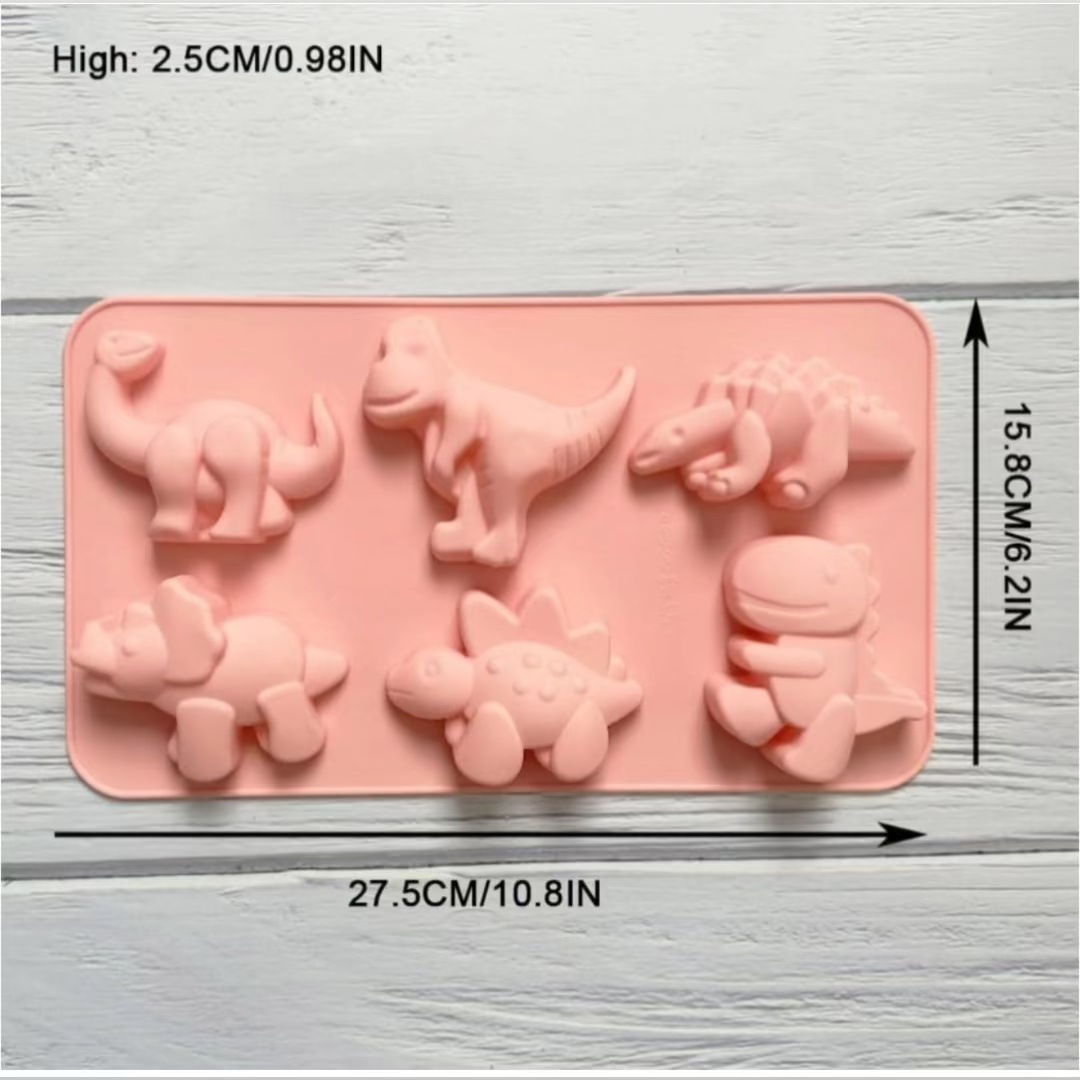 Pink 6-cavity dinosaur silicone baking mold displaying various dinosaur shapes and dimensions (27.5 cm x 15.8 cm).