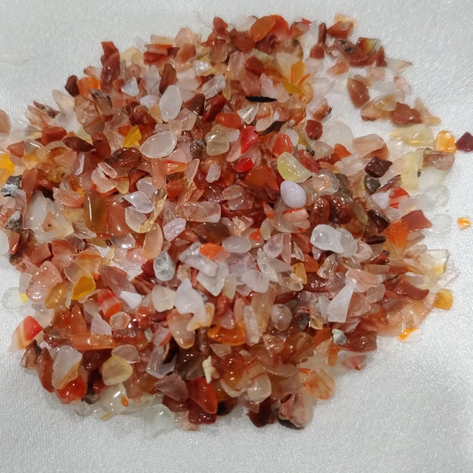 Small stones with red, orange, and white colors on a white background